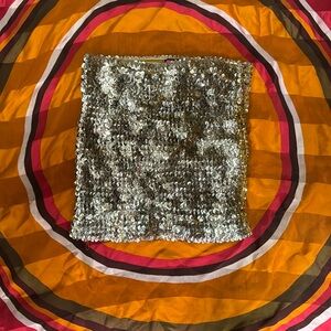 Say what? Sequin gold tube top (or mini skirt! She’s versatile!)